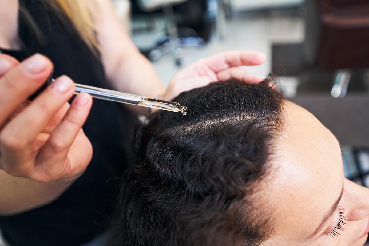 Close Up Of Woman Dropping Serum On Hair 2023 11 27 05 15 44 Utc