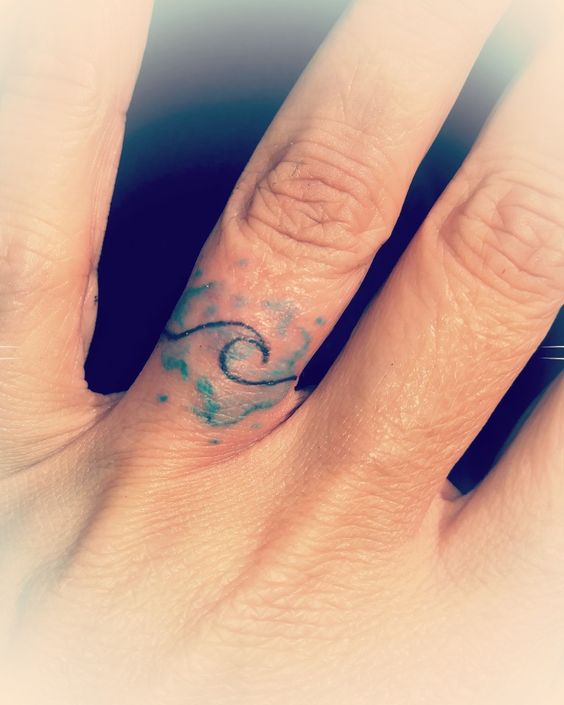 Tatouage Vague Et Aquarelle Bleue Sur Le Doigt