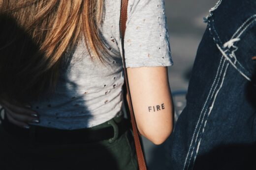 A Woman With A Tattoo On Her Arm